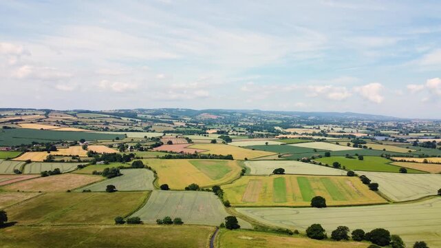Aerial flight over fields and countryside