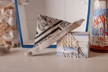 Handmade nautical decor with cloth boat and beach lettering