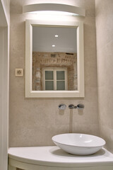 Elegant Bathroom Interior Featuring a Contemporary Sink and Stylish Mirror, Harmoniously Blending Modern Design with Timeless Charm