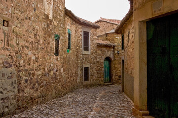 Fototapeta premium Old stone village street with traditional architecture