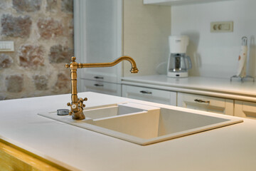 Modern Kitchen Design Featuring Elegant Brass Faucet and Minimalist Sink, Highlighting Functional and Aesthetic Aspects of Contemporary Interior Spaces
