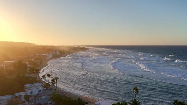Slow motion video of waves rolling in towards the beach in Puerto Rico at sunset. Cinematic aerial drone footage filmed near Jobo Beach in Isabella.