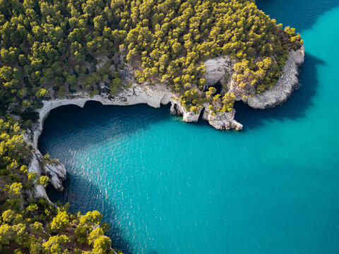Aerial view of the coastal area of Gargano peninsula with caves and cliffs. Beautiful white rocks above the turquoise Adriatic Sea.