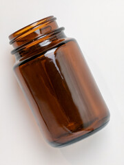 Empty brown glass jar on white background for pharmaceuticals or cosmetics