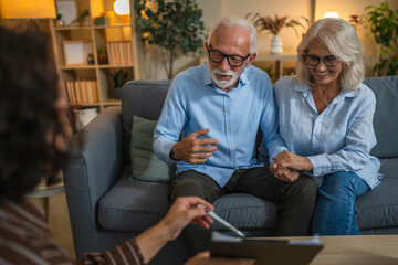 Senior couple engaged in negotiations with a consultant or agent
