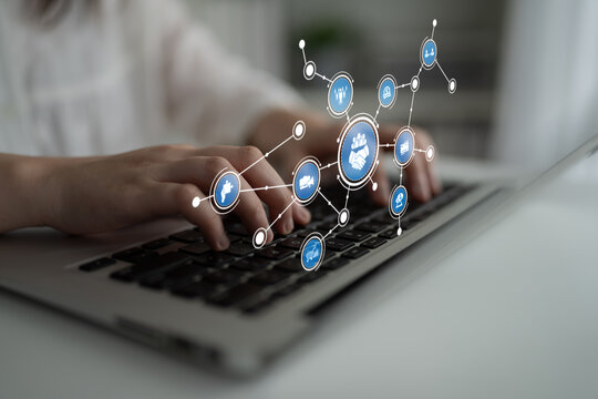 A person types on a laptop keyboard, featuring digital icons that symbolize technology and connectivity, showcasing modern communication and interaction. Tessel