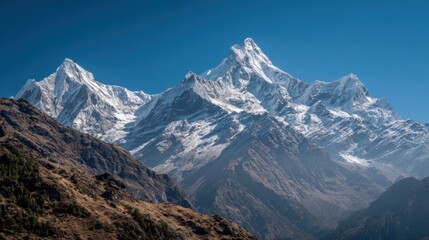 Fototapeta premium Snow-covered mountain peaks tower majestically i