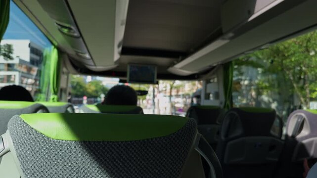 An InDepth Interior View of a Contemporary Bus Showcasing Beautiful Green Accents Bathed in Bright Daylight