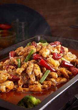 Wok-fried frog meat with cumin and chili peppers, closeup