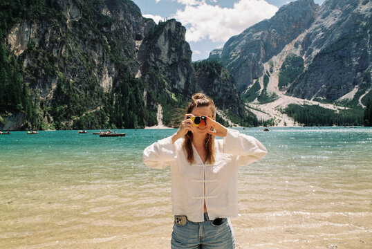 Tourist Taking Photo at Lago di Braies in the Dolomites
