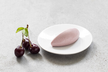 Cherry  dessert. Cherry cream quenelle. On a plate. Close-up