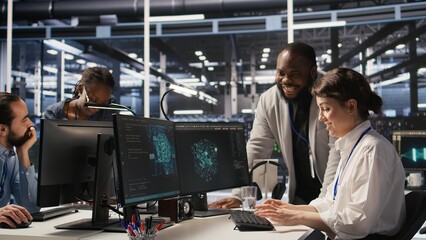 Joyous data center team leader giving high five to worker after successful infrastructure upgrade. Pleased coworkers celebrating collaborative achievement during AI systems deployment, camera A
