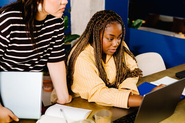 Black female executive at a startup works with a female freelancer