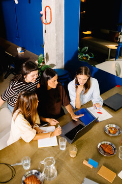 General view from above of a collaborative meeting of creative women