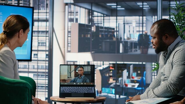 Multicultural group interacting in a corporate video call in a boardroom, focusing on business success through online planning and goal oriented leadership discussions. Camera B.