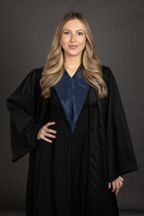 portrait of a young woman in a black graduation gown