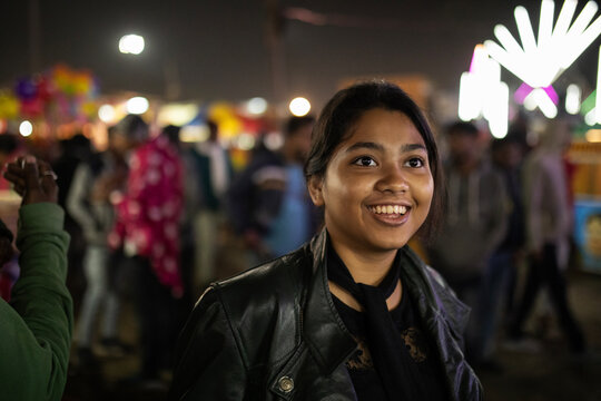 Close up portrait of a young girl in a fair looking happy and smiling