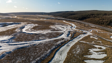 Aerial View Of Snowy river landscape with winding paths in Tolhuin