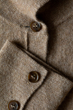 Knitted wool cardigan clothing button detail close up 