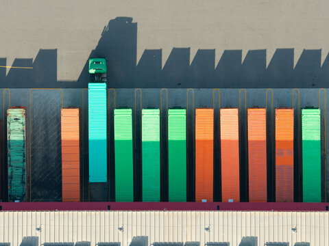 Colorful cargo containers and truck at warehouse yard
