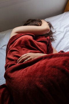 Woman Sleeping in Red Blanket