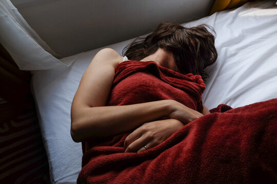 Woman Sleeping in Red Blanket
