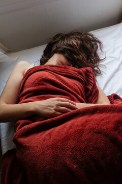 Woman Sleeping in Red Blanket