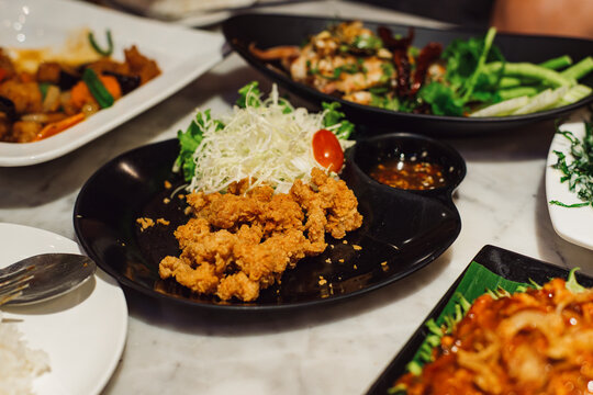 Thai dish deep fried chicken tendons served with salad and spicy sauce