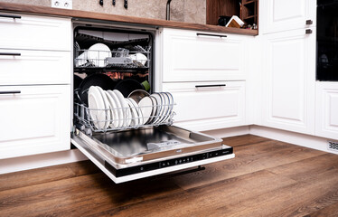 built-in dishwasher open with clean plates and utensils in stylish kitchen