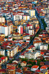 Naklejka premium Aerial View of Pogradec City with Colorful Buildings and Red Tiled Roofs at Sunset, Albania