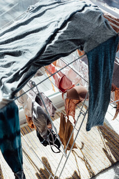 A damp shirt and other clothing on a drying rack on a cold day