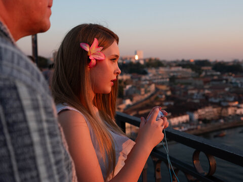 Teen Girl and Dad look at sunset from Dom Luis Bridge in Porto
