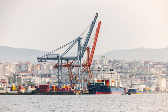 Container port in vigo with cranes and city skyline
