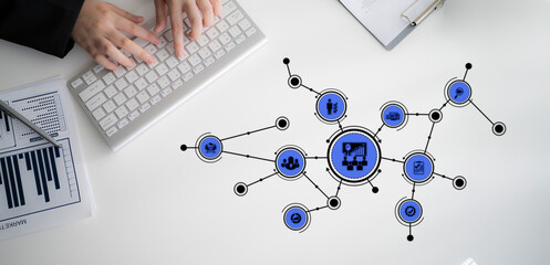 A professional workspace featuring hands typing on a keyboard with data visualization graphics representing business analytics, digital marketing, and strategic connections. Tessel