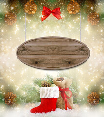 Christmas frame background with wooden signboard, decorative Santa's boot and gift bag, branch and cones for tree decoraton. New Year winter holidays fantasy concept with board for text message.