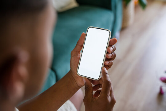 Person holding smartphone with blank screen