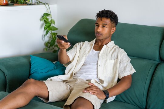 man watching television changing channels
