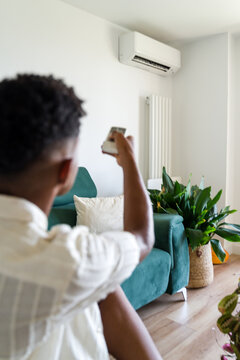 Man adjusting air conditioning temperature 