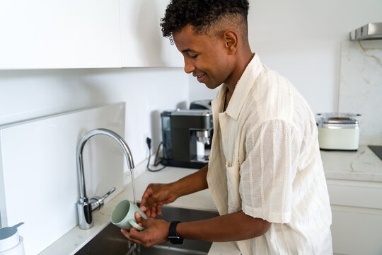 Man washing a mug 