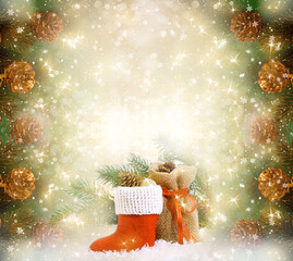 Christmas frame background with decorative Santa's red boot and gift bag, branch and pine cones for tree decoraton. New Year winter holidays fantasy card with decor and copy space, festive postcard.