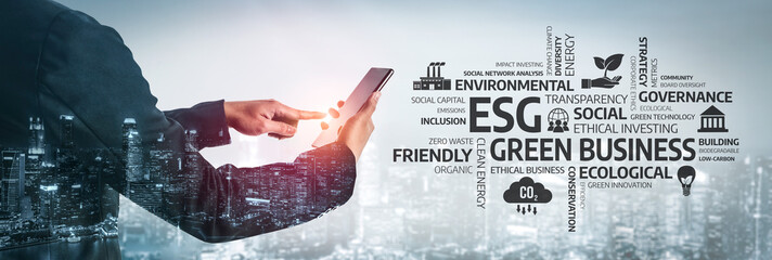 A business professional interacts with digital technology while exploring ESG concepts, emphasizing green investments and ethical practices in contemporary business environments. Tessel