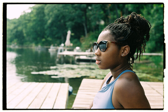 Girl Enjoying a Summer Day at the Lake Wearing Sunglasses