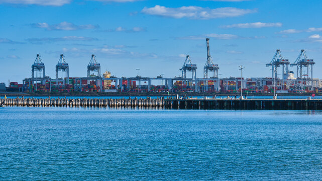 Port of Melbourne cranes with cargo activity in distance