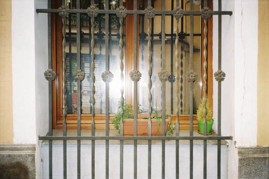 Window With Decorative Bars and Potted Plants in a Gracia, Barcelona
