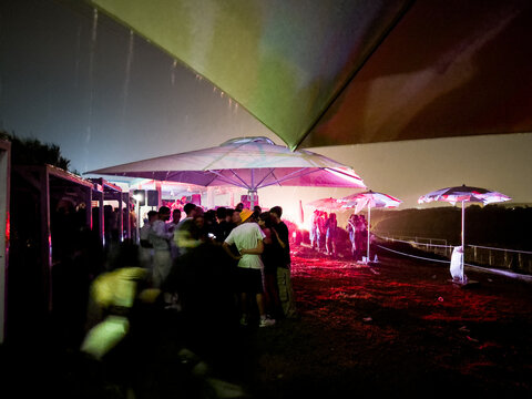 Gathering Under Umbrellas During a Rainstorm 