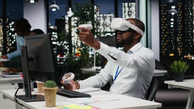 Young black businessman using virtual reality headset and other devices to build a strategy, forecasting projections and documenting risk assessment for success. Business goals. Camera B. - Powered by Adobe