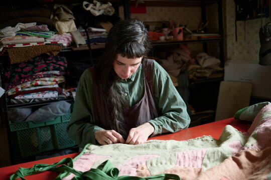 Crafting a quilt with precision in a cozy workshop space