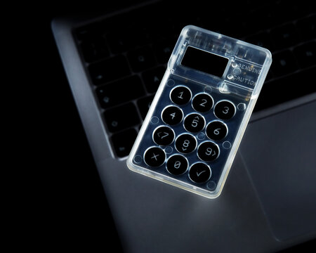 Bitcoin cold storage hardware wallet floating over laptop