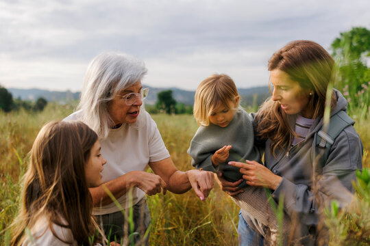 Grandmother, mother and granddaughters enjoying a fall day outdoors