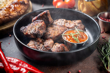 Grilled pork barbecue with spicy sauce and herbs